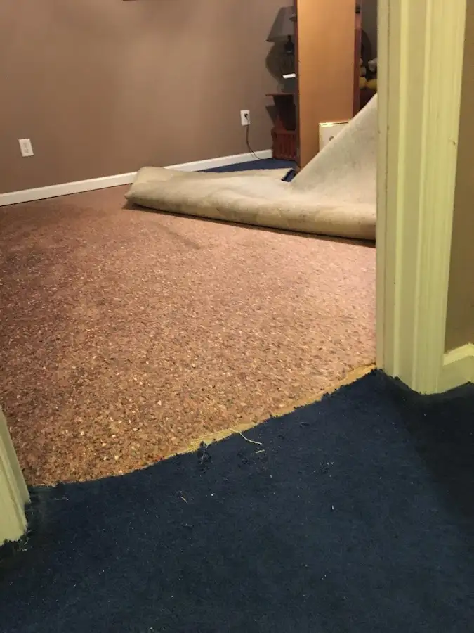 Carpet pad removal revealing water damage during Drying & Dehumidification in Parole